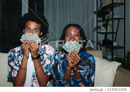 Funny young Black couple posing with playing cards Funny young Black couple posing with playing cards 115052204