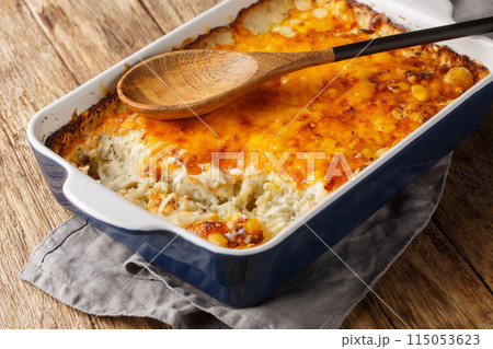 Hash brown casserole is quick and easy comfort food made with oven-baked cheesy potatoes in cream of chicken closeup in the baking dish. Horizontal Hash brown casserole is quick and easy comfort food made with oven-baked cheesy potatoes in cream of chicken closeup in the baking dish. Horizontal 115053623