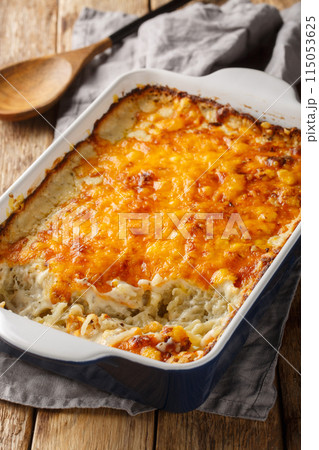 Hashbrown casserole is creamy, hearty meal is perfect for potlucks, parties, and to serve as a side closeup in the baking dish. Vertical Hashbrown casserole is creamy, hearty meal is perfect for potlucks, parties, and to serve as a side closeup in the baking dish. Vertical 115053625