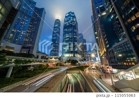 Skyscraper buildings and traffic on road with blurred cars light trails at night, Hong Kong, China 115055063