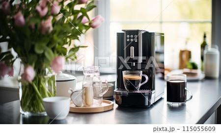 Modern coffee machine with a glass cup of latte or cappuccino on a bright kitchen near the window. 115055609
