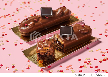 Chocolate bars with streusel, caramelized fruits and pecans on pink Chocolate bars with streusel, caramelized fruits and pecans on pink 115056627