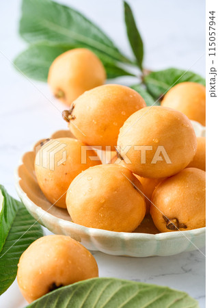 皿に盛った大粒のびわ 115057944
