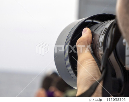 Wildlife photographer using tele lens on a whale watching boat Wildlife photographer using tele lens on a whale watching boat 115058393