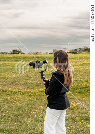 Woman with camera in field, Cloud, Sky, Gesture, Happy, Grass, Photographer Woman with camera in field, Cloud, Sky, Gesture, Happy, Grass, Photographer 115058651