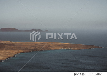 An aerial view captures a small island in the midst of the ocean 115058658