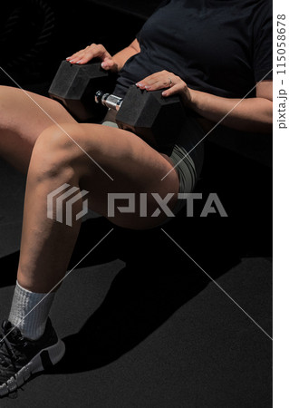 Woman in sportswear with dumbbells keywords hand, waist, finger, knee Woman in sportswear with dumbbells keywords hand, waist, finger, knee 115058678