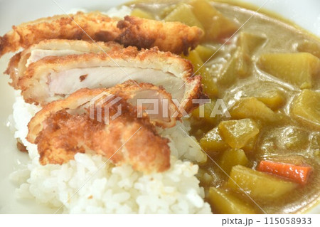 Tonkatsu crispy fried pork slice topping plain rice dressing potato and carrot in Japanese curry on plate Tonkatsu crispy fried pork slice topping plain rice dressing potato and carrot in Japanese curry on plate 115058933