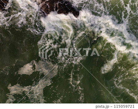 Aerial view of Waves crashing on seashore,Sea surface ocean waves background Aerial view of Waves crashing on seashore,Sea surface ocean waves background 115059721