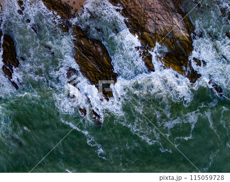 Bird eye view seashore with big wave crashing on rock cliff. Beautiful waves sea surface in sunny day summer background, Amazing seascape top view seacoast landscape view 115059728