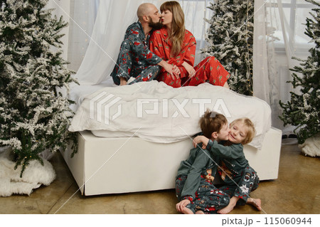 A large family with children posing in pajamas in New Year's locations. 115060944