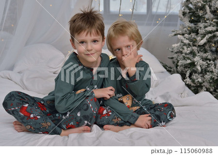 A large family with children posing in pajamas in New Year's locations. A large family with children posing in pajamas in New Year's locations. 115060988