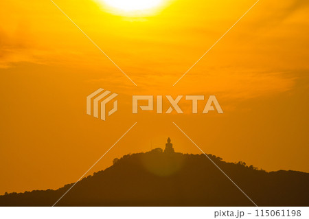 Amazing orange sky behind Phuket big Buddha in sunset. Amazing orange sky behind Phuket big Buddha in sunset. 115061198