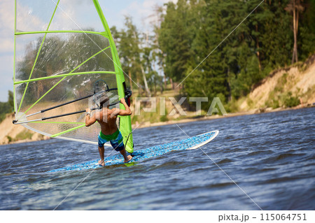 Windsurfer passing by Windsurfer passing by 115064751