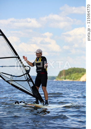 Side view of a funny windsurfer Side view of a funny windsurfer 115064770