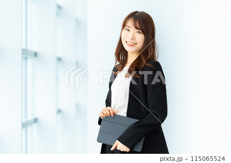 タブレットを持つ笑顔のビジネスウーマン 115065524