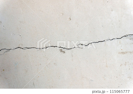 Cracked concrete cement wall in an industrial building, great for your design and background texture Cracked concrete cement wall in an industrial building, great for your design and background texture 115065777