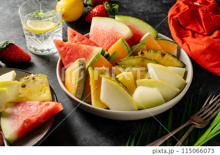 Fruits assortment platter antipasti, watermelon, pineapple, melon and strawberries. Dark background 115066073