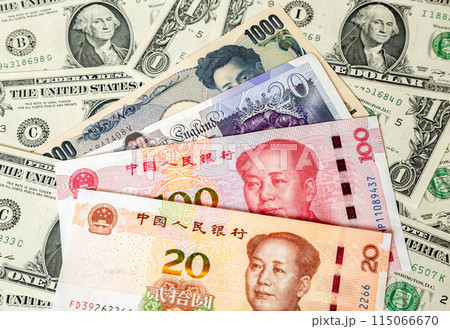 Various banknotes of Chinese and other currency on the dollar bills background Various banknotes of Chinese and other currency on the dollar bills background 115066670