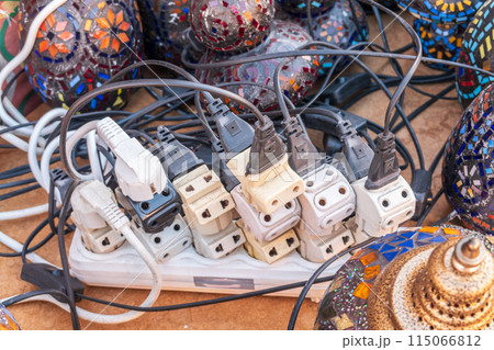 Old and damaged electric adapter power plug has many appliances are plugged outlet socket concept of risk danger overloaded current electrical. Overloaded power plugs, close up Old and damaged electric adapter power plug has many appliances are plugged outlet socket concept of risk danger overloaded current electrical. Overloaded power plugs, close up 115066812