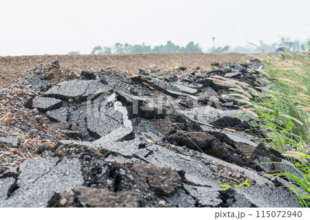 Asphalt surface on the street was demolished due to poor construction. Asphalt surface on the street was demolished due to poor construction. 115072940