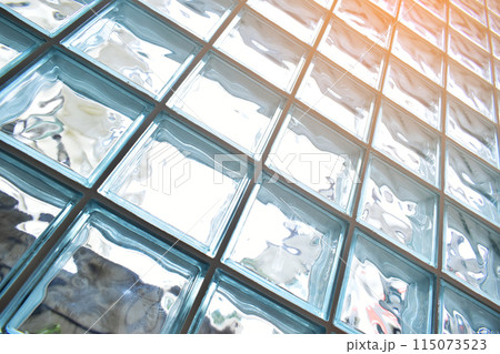 close up glass block wall with golden natural light background, interior design close up glass block wall with golden natural light background, interior design 115073523