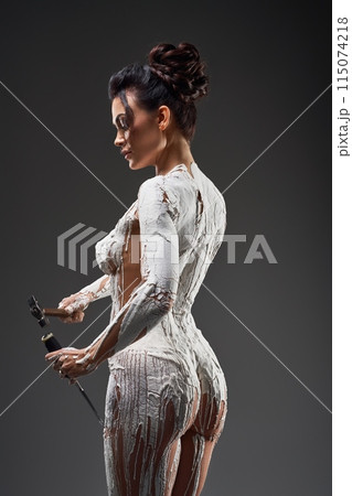 Nude self made woman statue in gray studio 115074218
