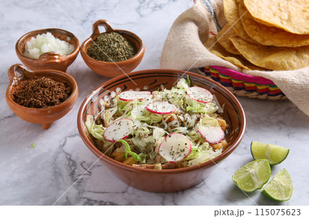 Pozole rojo, Mexican corn soup, traditional food in Mexico made with corn kernels and pork. 115075623