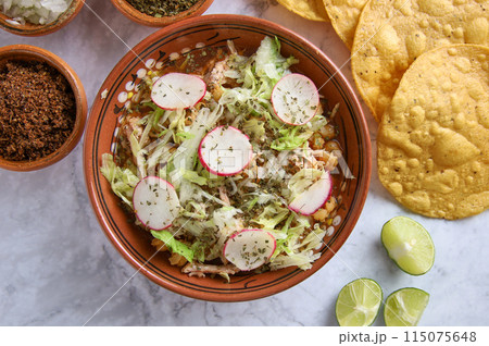 Pozole rojo, Mexican corn soup, traditional food in Mexico made with corn kernels and pork. 115075648