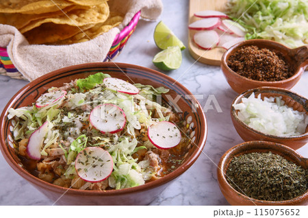 Pozole rojo, Mexican corn soup, traditional food in Mexico made with corn kernels and pork. 115075652