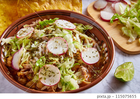 Pozole rojo, Mexican corn soup, traditional food in Mexico made with corn kernels and pork. 115075655