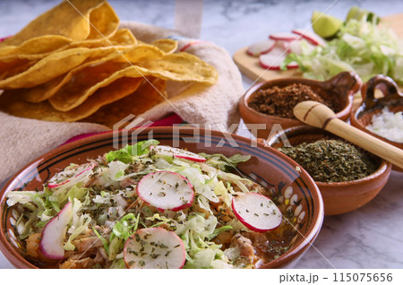 Pozole rojo, Mexican corn soup, traditional food in Mexico made with corn kernels and pork. 115075656