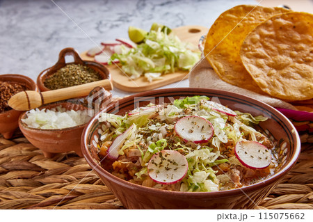 Pozole rojo, Mexican corn soup, traditional food in Mexico made with corn kernels and pork. 115075662