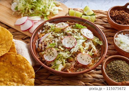 Pozole rojo, Mexican corn soup, traditional food in Mexico made with corn kernels and pork. 115075672