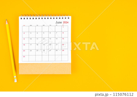 June 2024 desk calendar and wooden pencil on yellow color background. Time planning. 115076112
