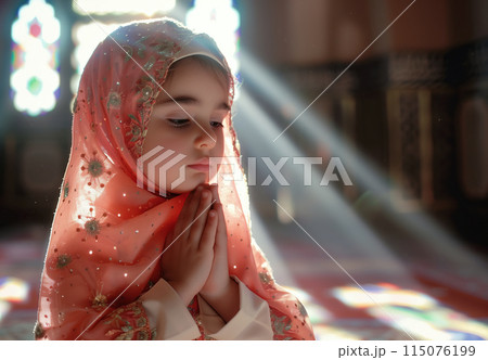 A cute little Muslim girl prays, her small hands raised in devotion. The innocence and purity of a child faith. Generative AI. 115076199
