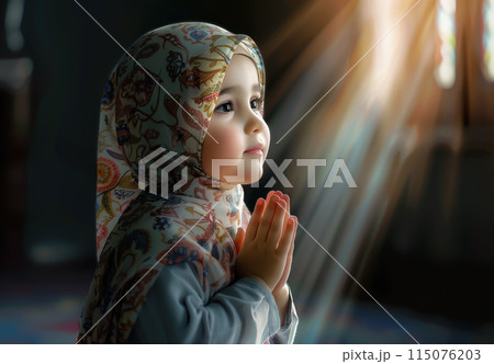 A cute little Muslim girl prays, her small hands raised in devotion. The innocence and purity of a child faith. Generative AI. 115076203