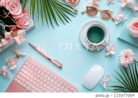 Pink keyboard on a blue background with a cup of green tea and a pen, flowers and palm leafs. Scene is relaxed and serene 115077004