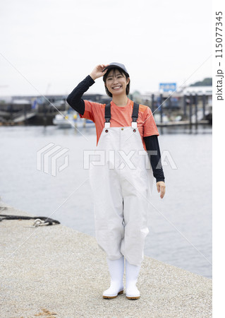 魚港に立つ若い女性 115077345