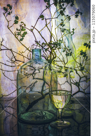 Still life with glassware and a plant branch Still life with glassware and a plant branch 115079060