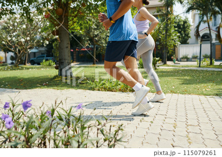 Couple Running Together in Park 115079261