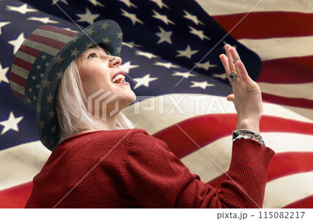 Independence Day. Happy young woman dressed in american flag clothes on american flag background Independence Day. Happy young woman dressed in american flag clothes on american flag background 115082217