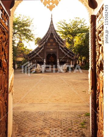 Old Temple in Chiang Mai, Thailand. Old Lanna temple - Wat Pan Sao and carved wood gate 115082435