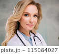 Close-up of woman in white lab coat and stethoscope 115084027
