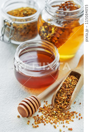 Raw organic bee pollen and honey in jars. 115084055