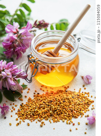 Raw organic bee pollen and honey in jars. Raw organic bee pollen and honey in jars. 115084059