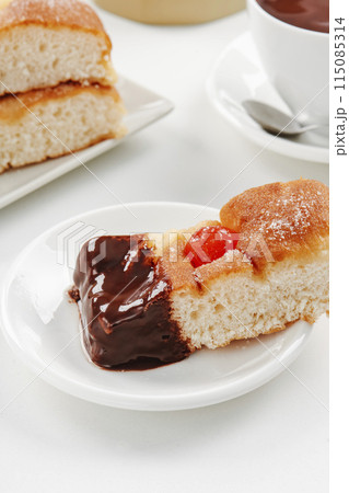 catalan coca de sant joan dipped in hot chocolate 115085314
