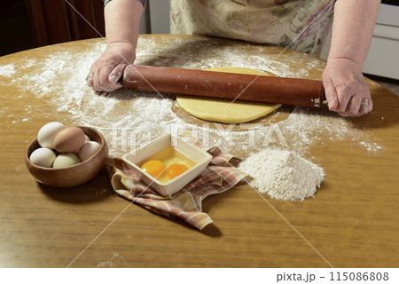 Egg dough for noodles, with ingredients on the table. Egg dough for noodles, with ingredients on the table. 115086808