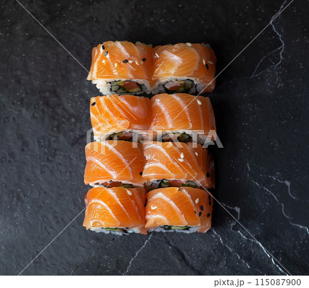 Sushi set with wasabi and ginger on black stone tray on black table. Top view. 115087900