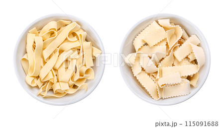 Two types of short thick ribbon pasta, uncooked durum wheat semolina noodles with egg, Italian laminated pasta in white bowls. Smooth ribbons, called sagnette, and serrated ribbons, called rustiche. Two types of short thick ribbon pasta, uncooked durum wheat semolina noodles with egg, Italian laminated pasta in white bowls. Smooth ribbons, called sagnette, and serrated ribbons, called rustiche. 115091688